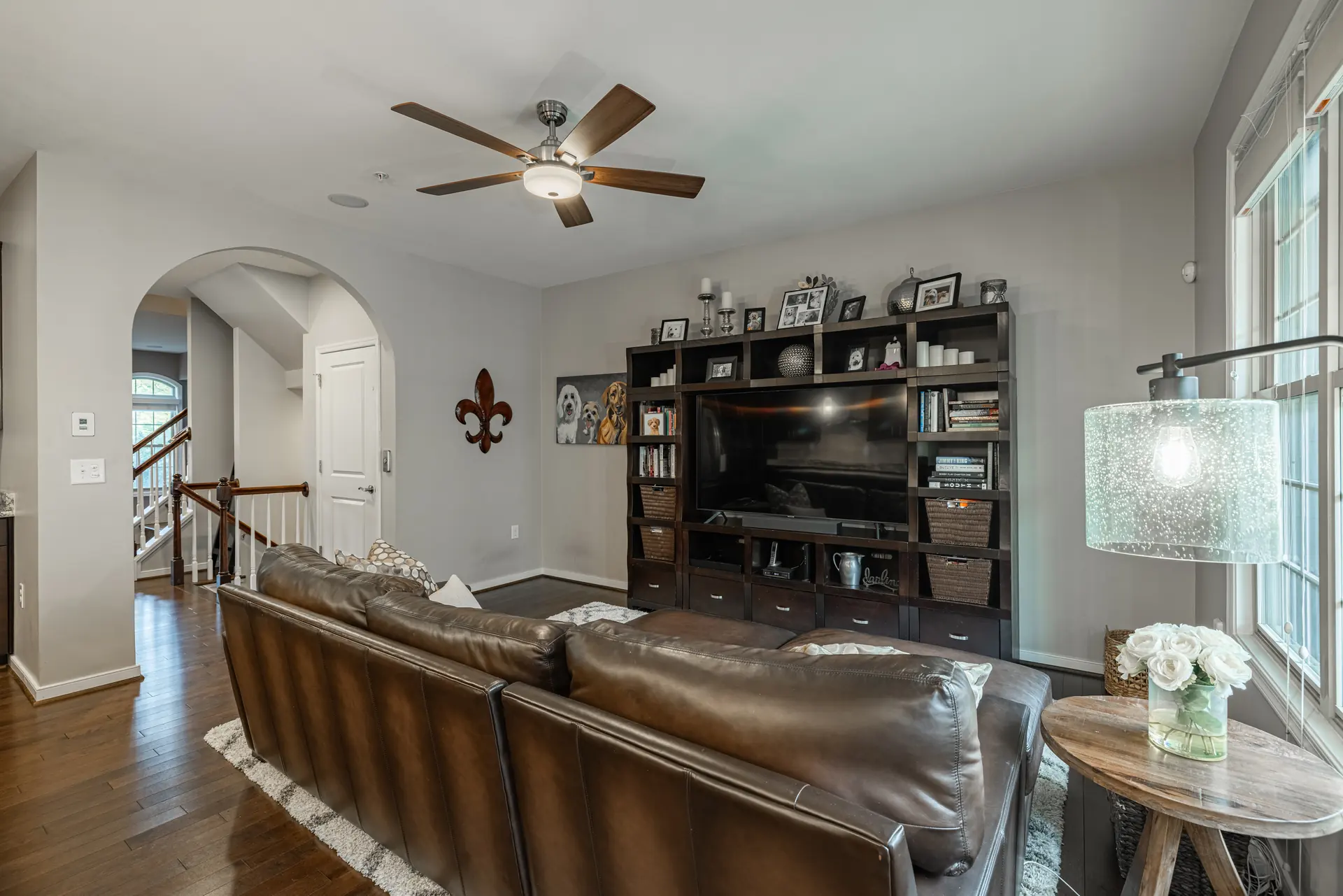Family room looking toward the arched hallway and staircase