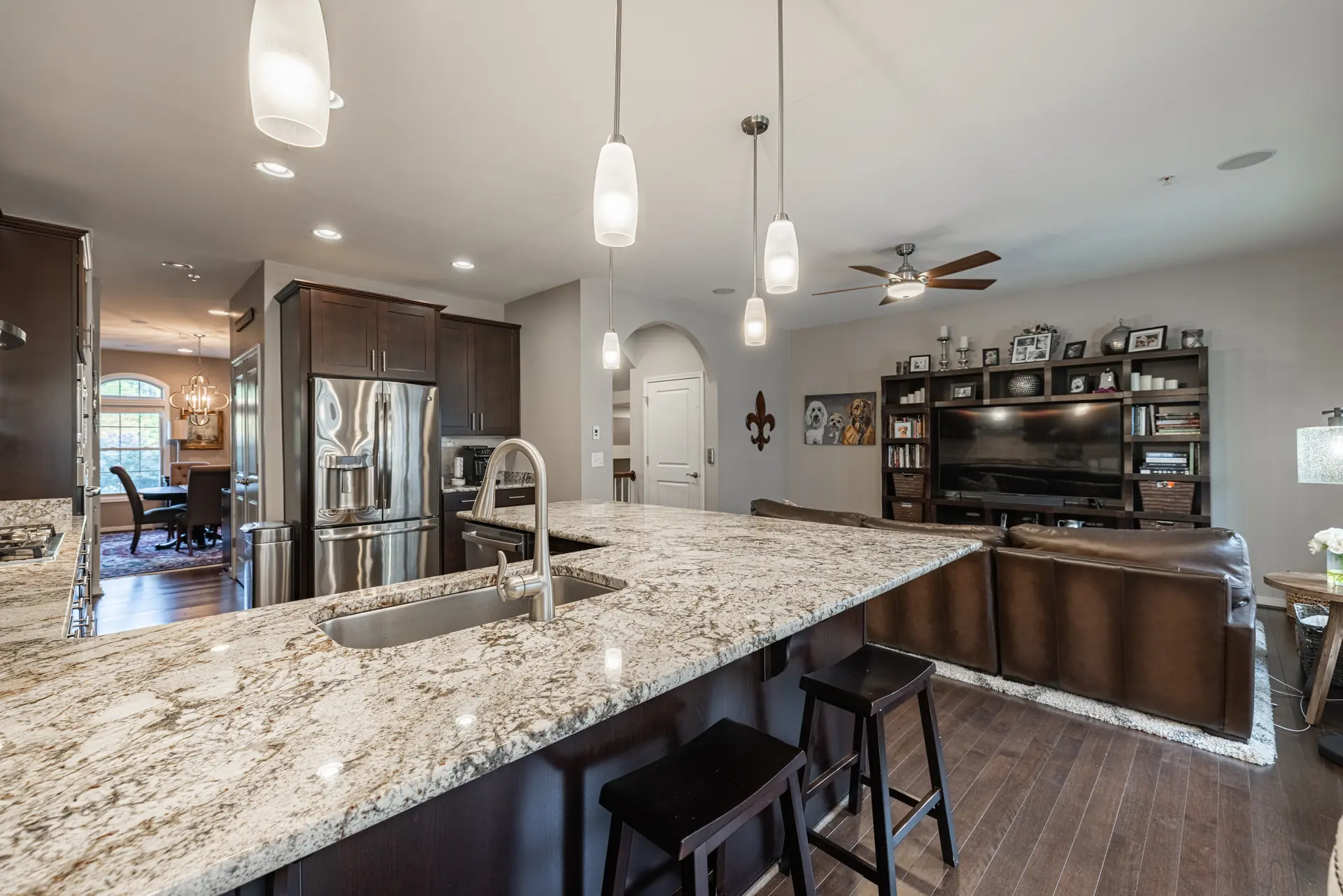 Granite kitchen island with bar seating, open to the family room