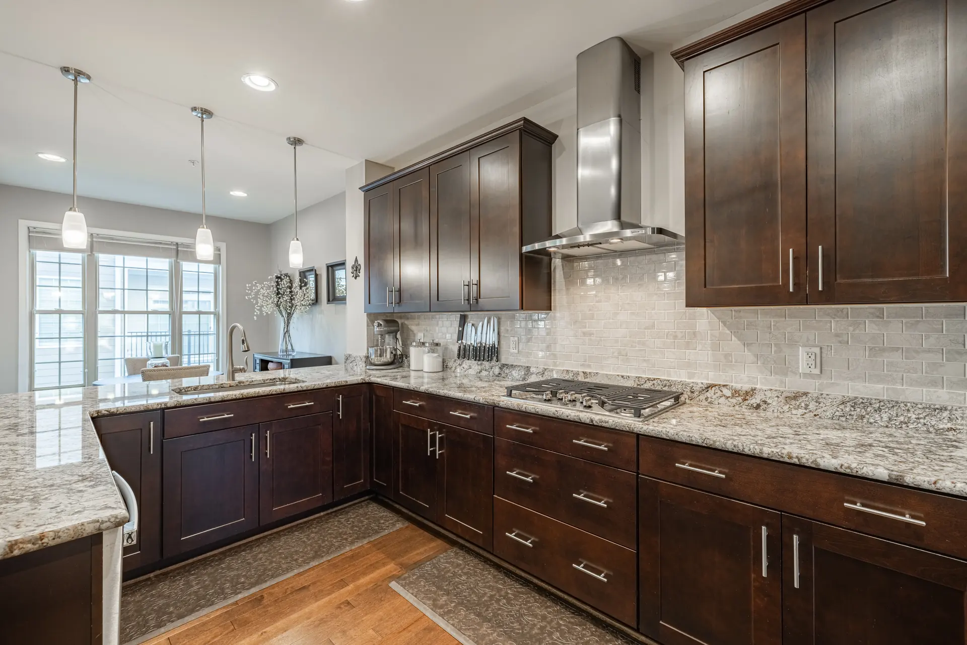 Kitchen cabinetry wall with gas cooktop and subway-tile backsplash