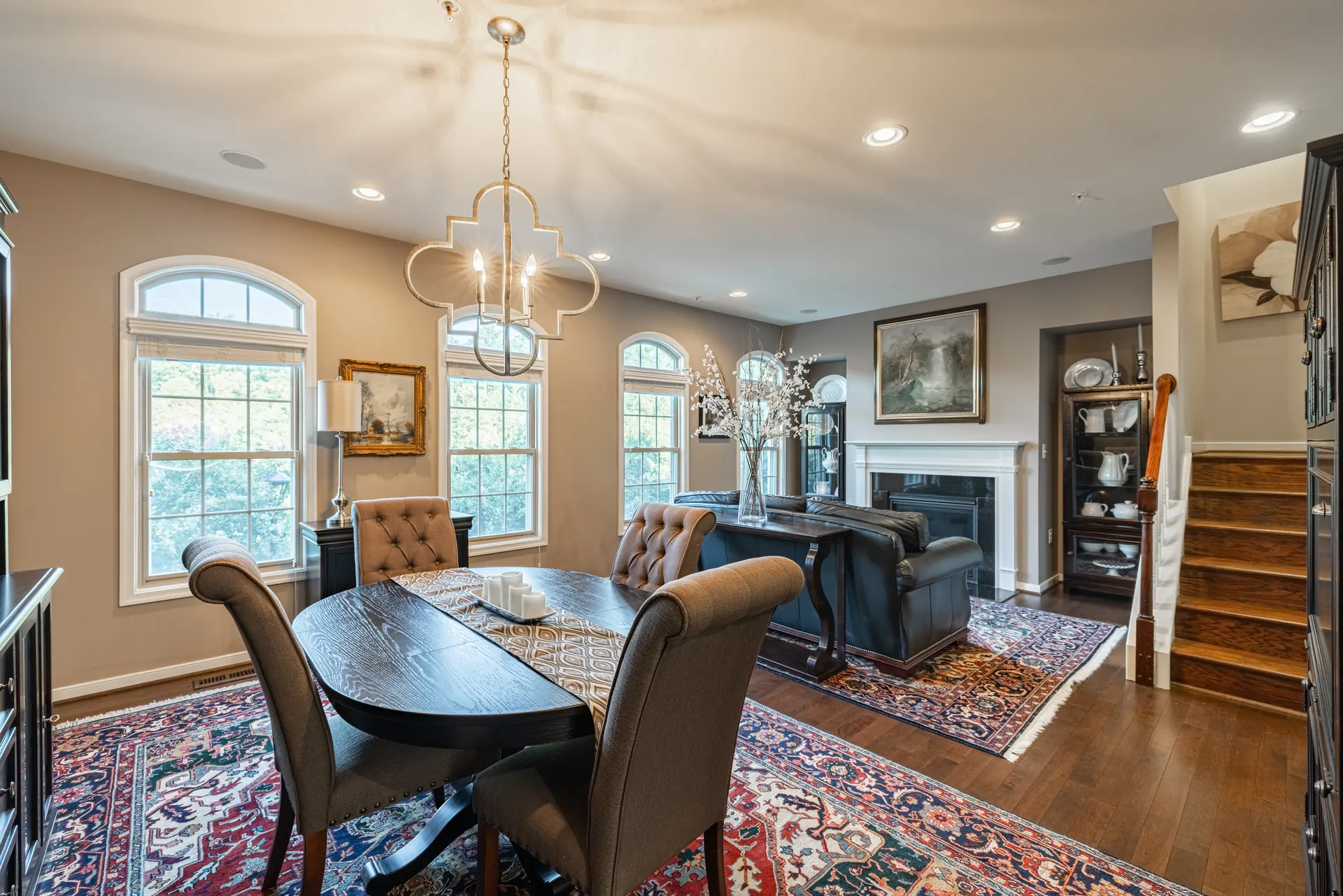 Dining room with chandelier, arched windows and adjoining sitting area