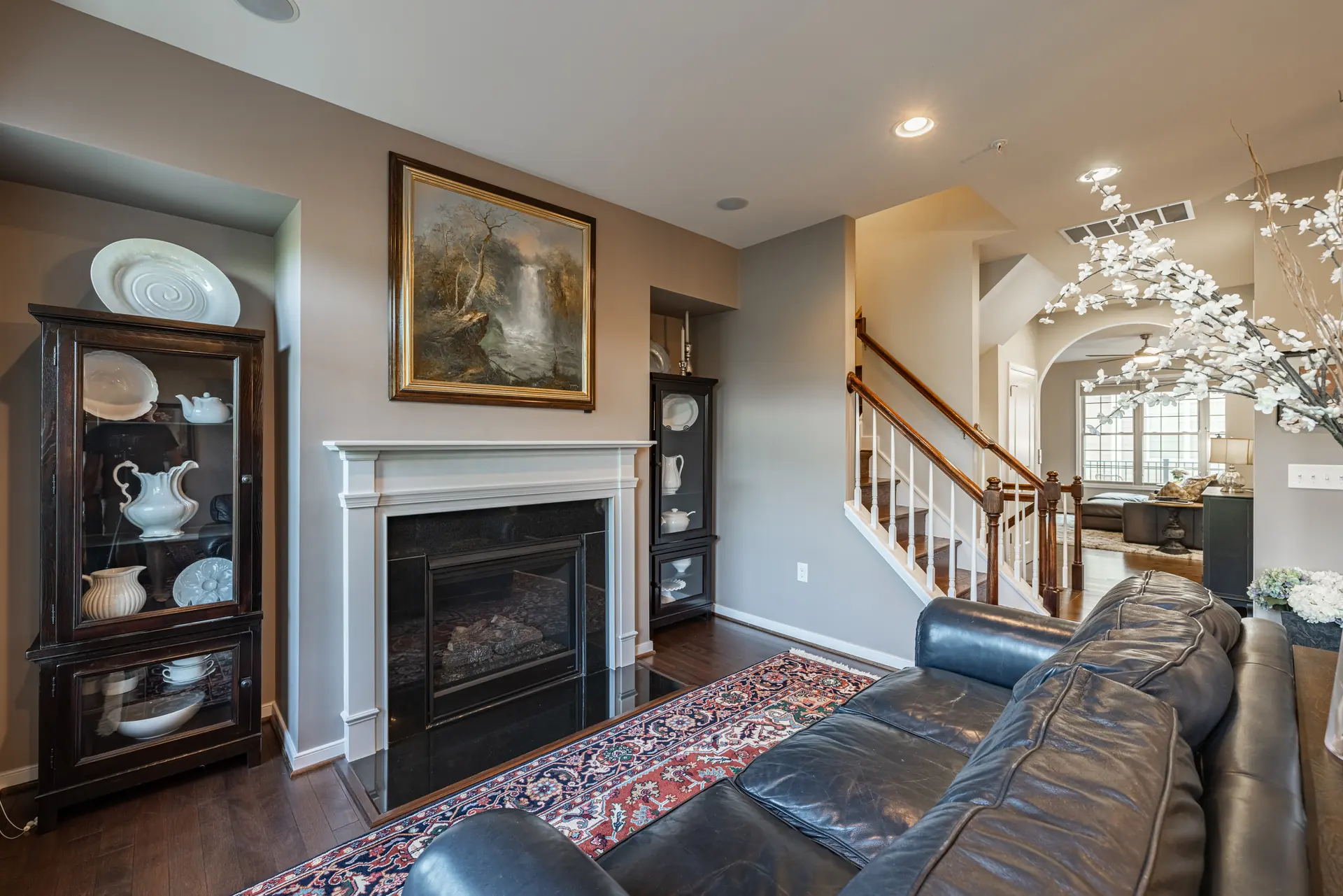 Sitting room with gas fireplace and a view to the staircase