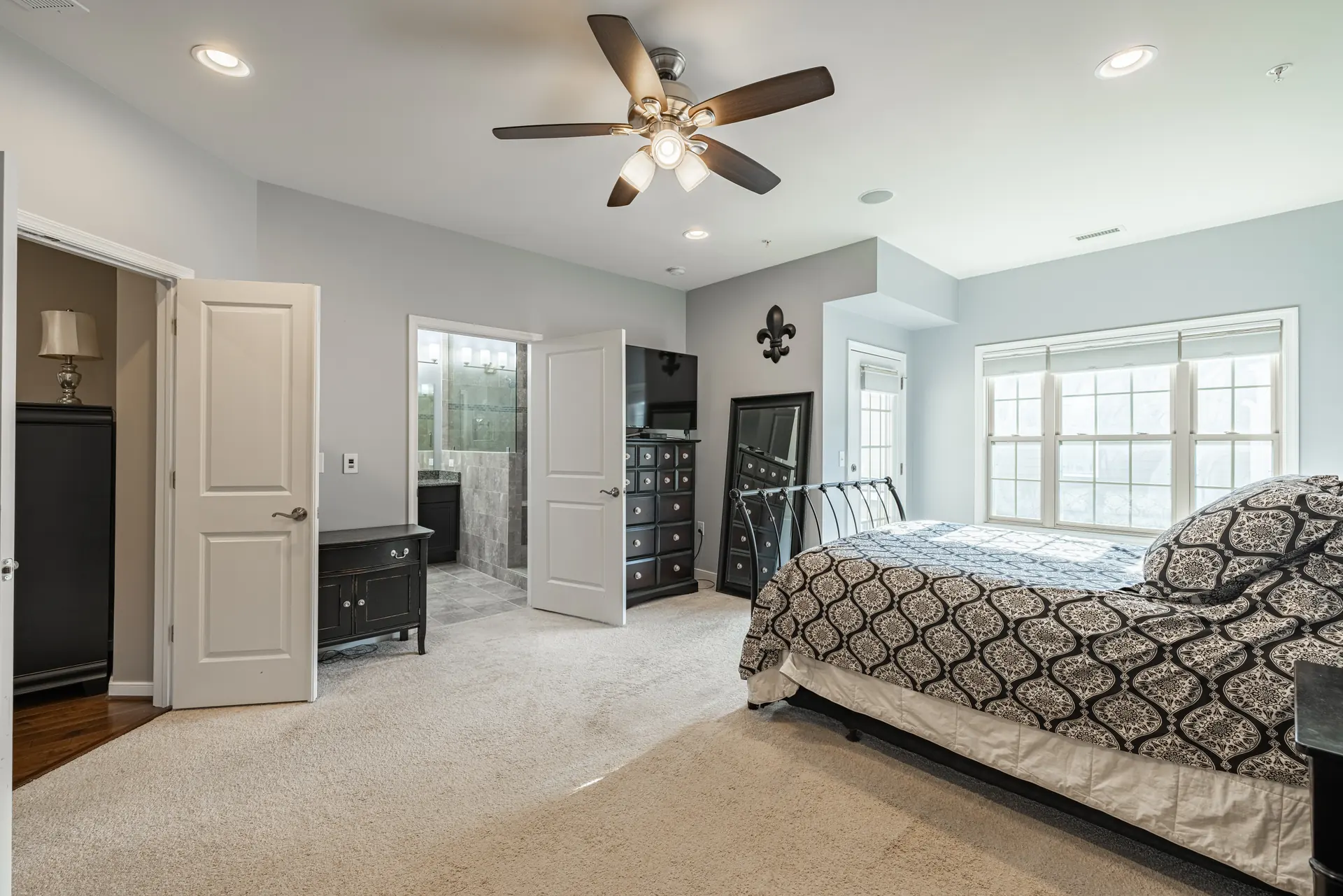 Primary bedroom with doors to the bath and walk-in closet