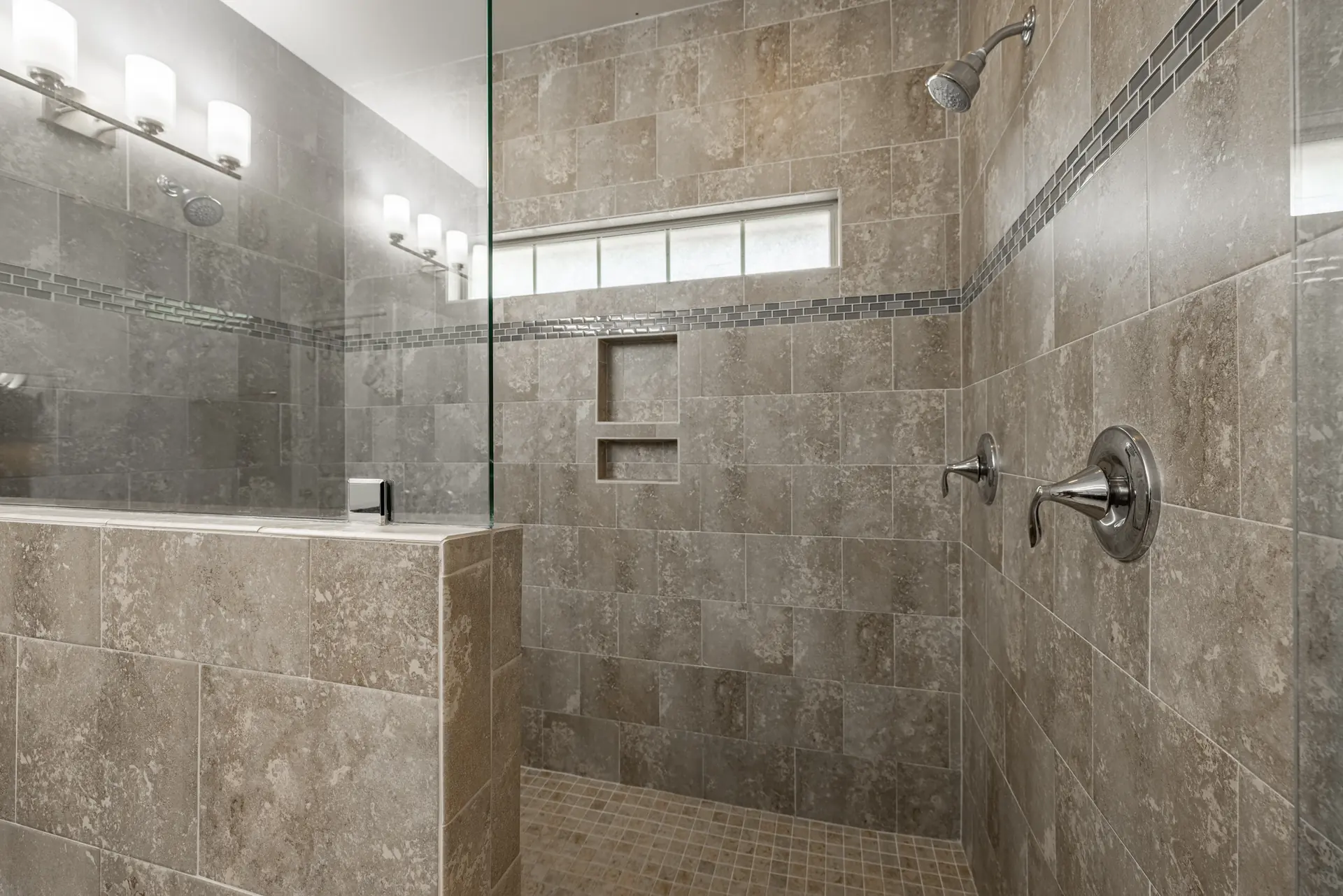 Tiled walk-in shower in the primary bath