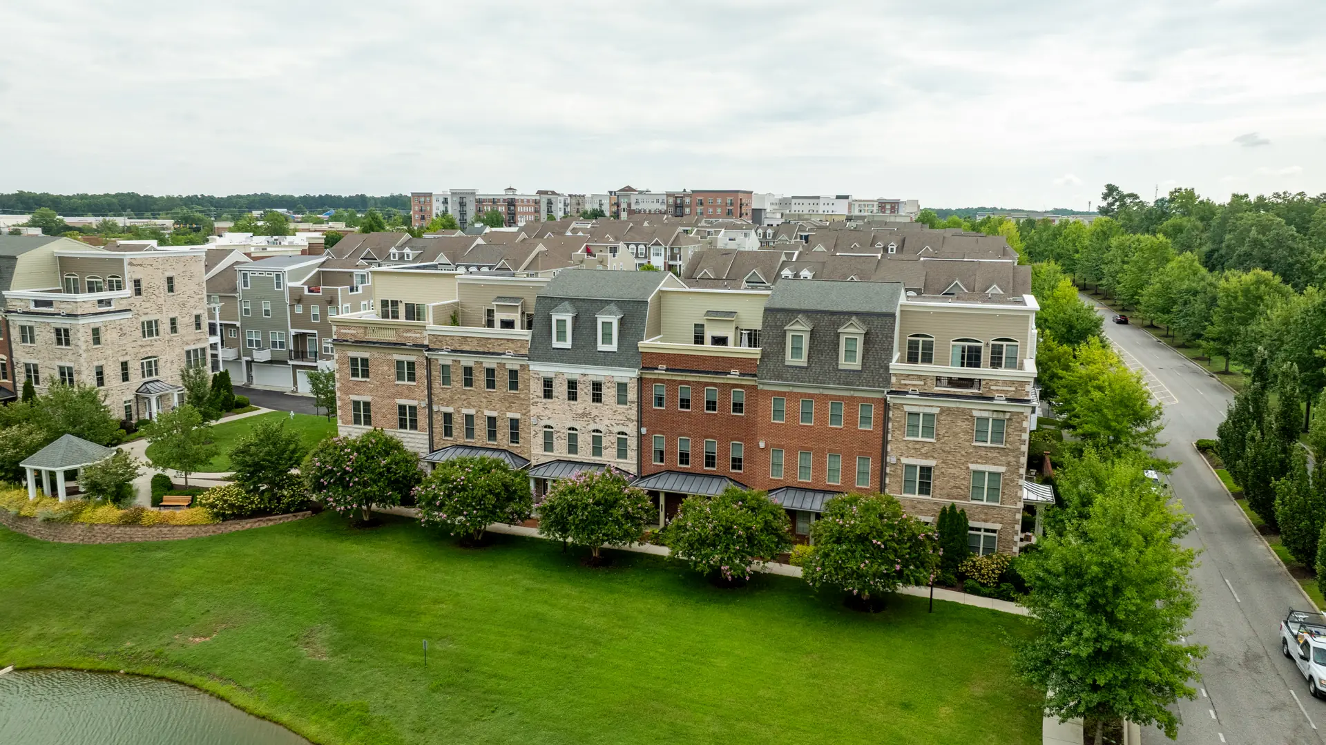 Aerial view of the brick townhome row and open green space