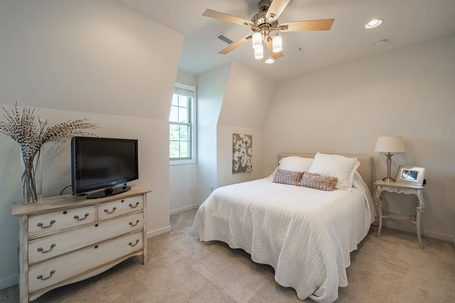Bedroom with dormer window and ceiling fan
