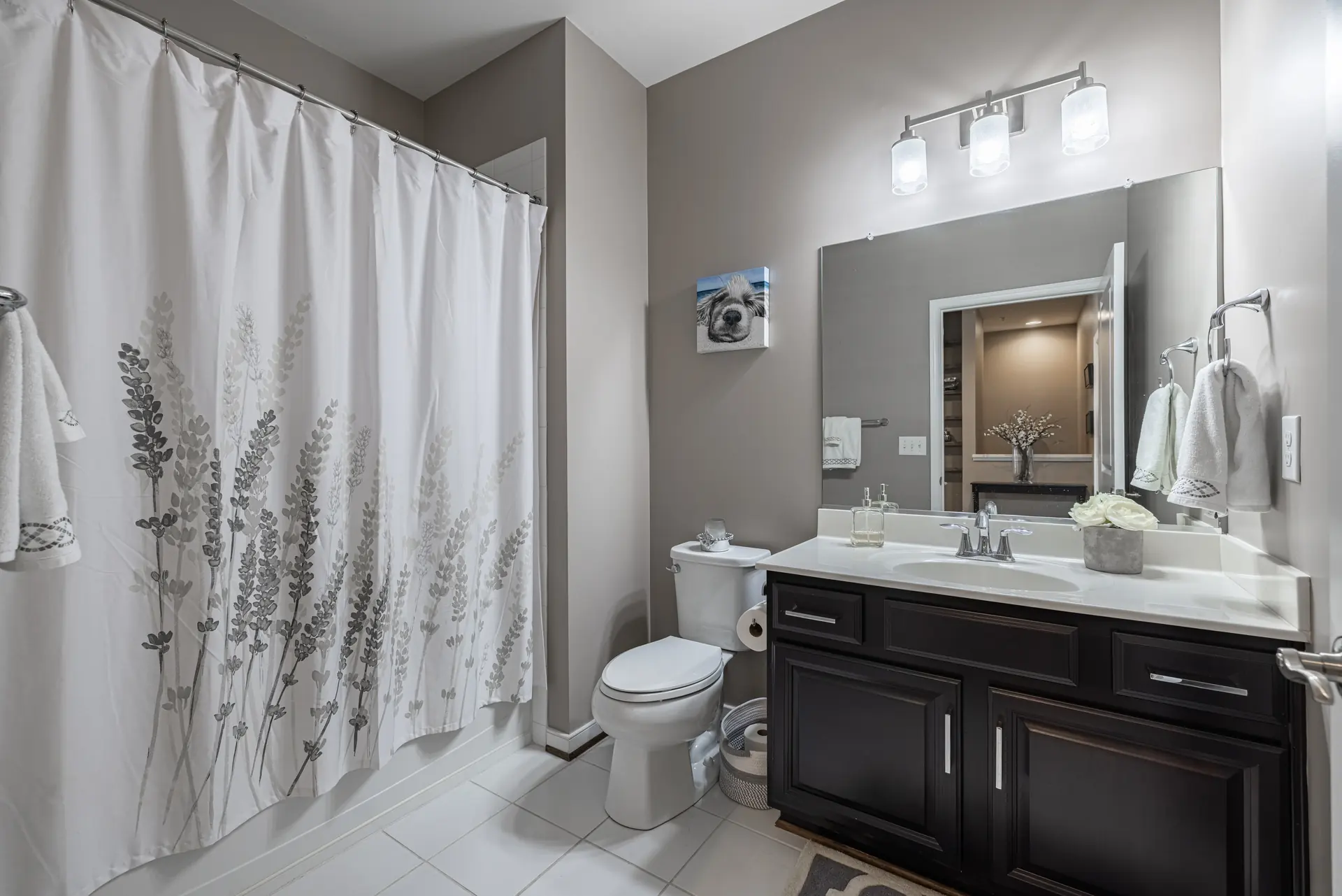 Full bath with dark wood vanity