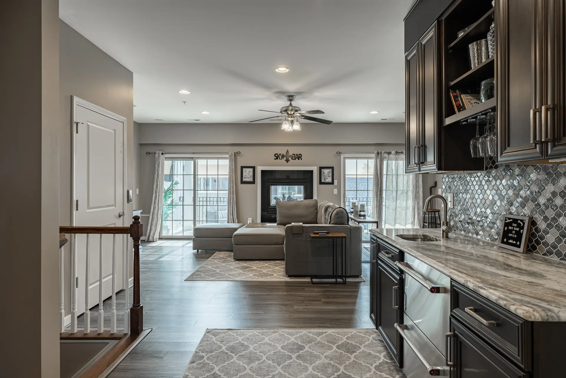 Upper-level living room with wet bar and two-sided fireplace