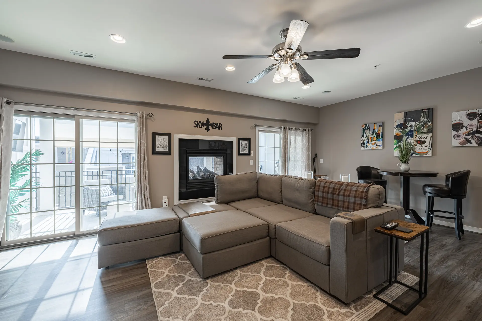 Upper-level living room with sectional and sliding doors to the porch