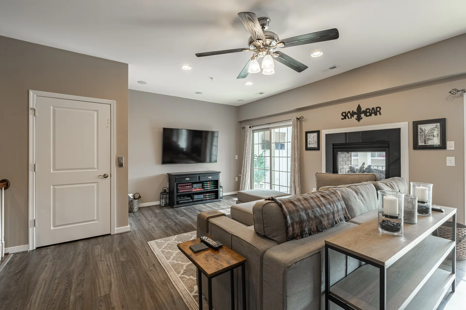 Upper-level living room with mounted TV and two-sided fireplace