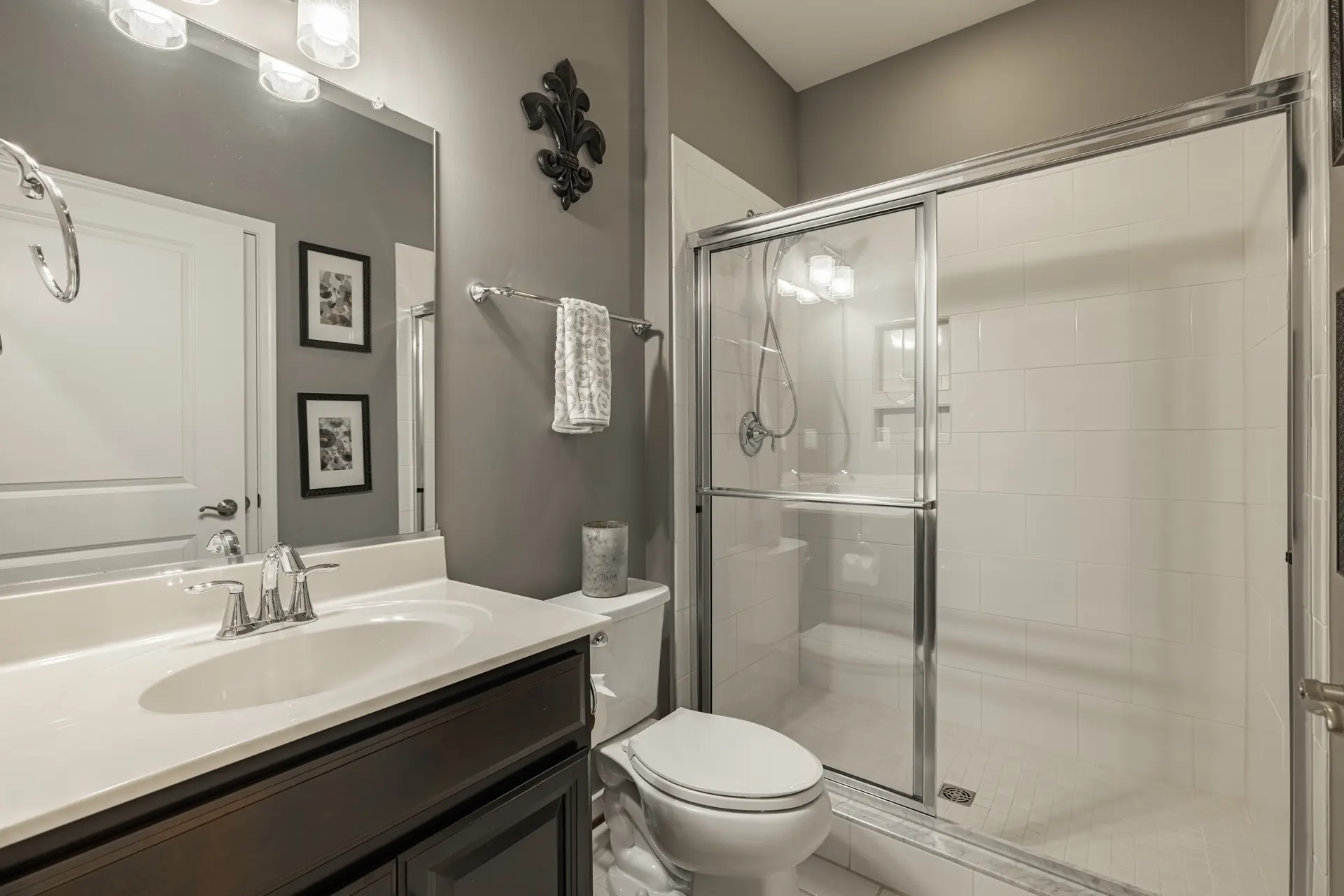 Full bath with glass shower and dark vanity