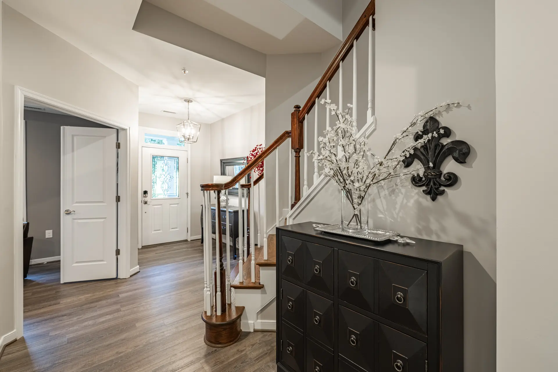 Entry foyer with staircase and front door