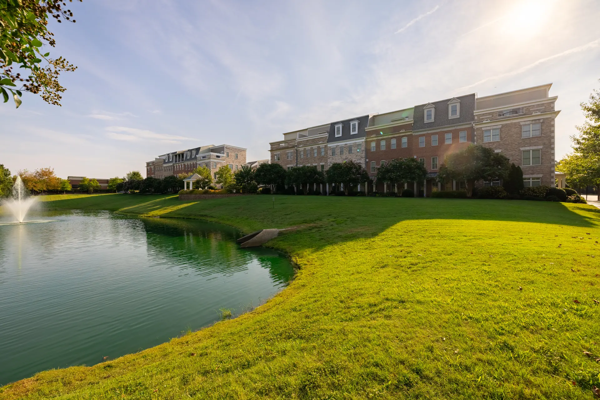 Pond and fountain with the townhome row beyond