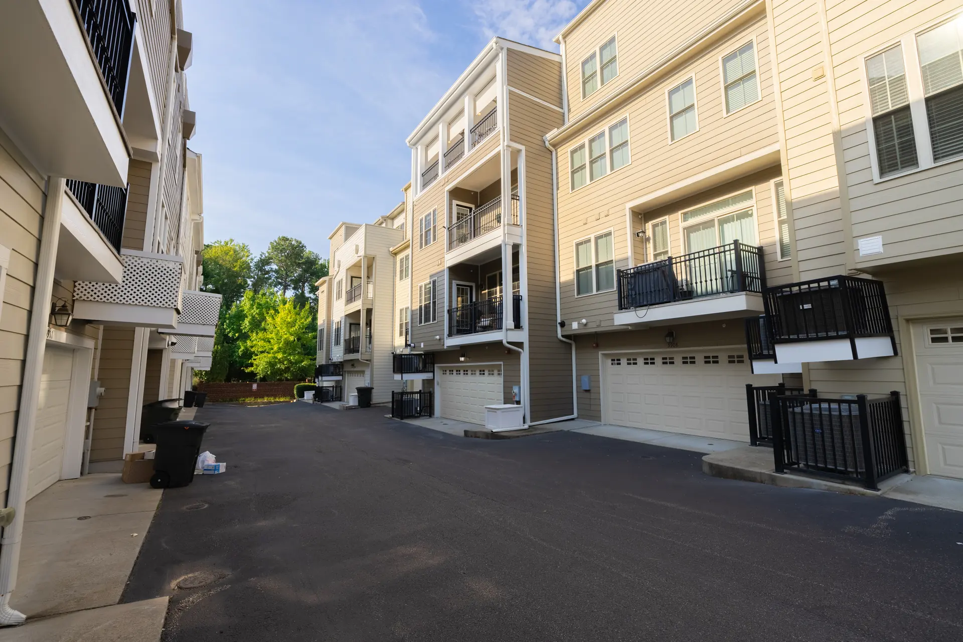 Rear lane with attached garages and upper-level balconies