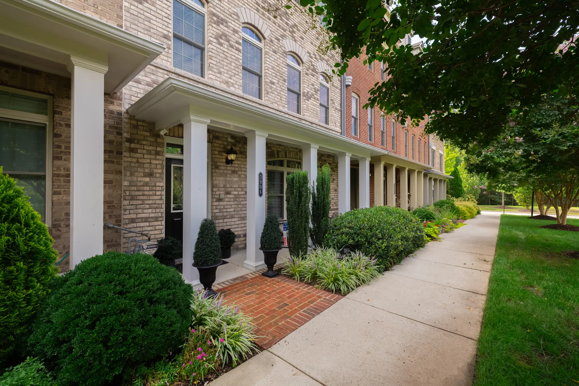 Brick front elevation and columned entry of 3906 Village Commons Walk