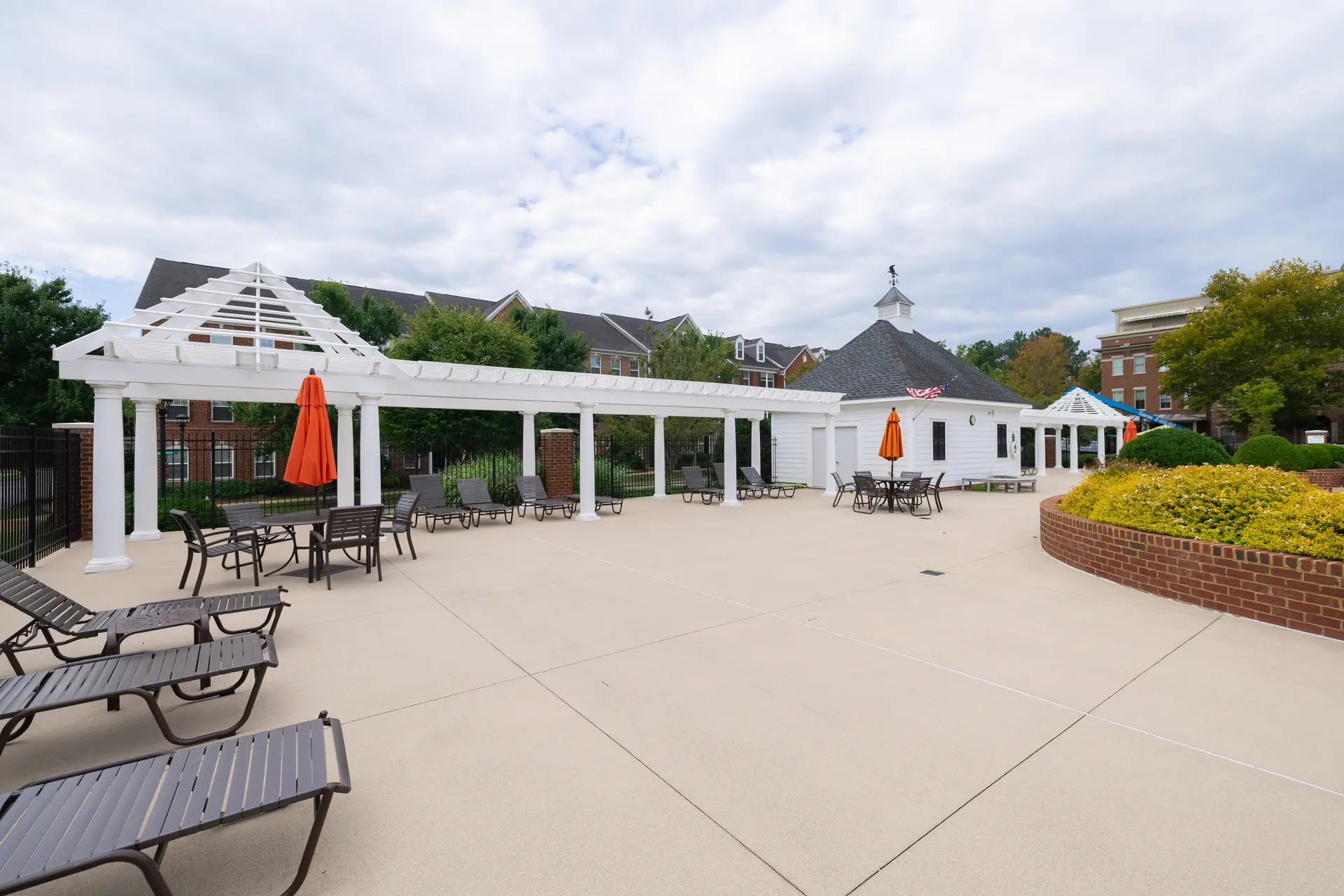 Shaded pergola and lounge chairs at the pool