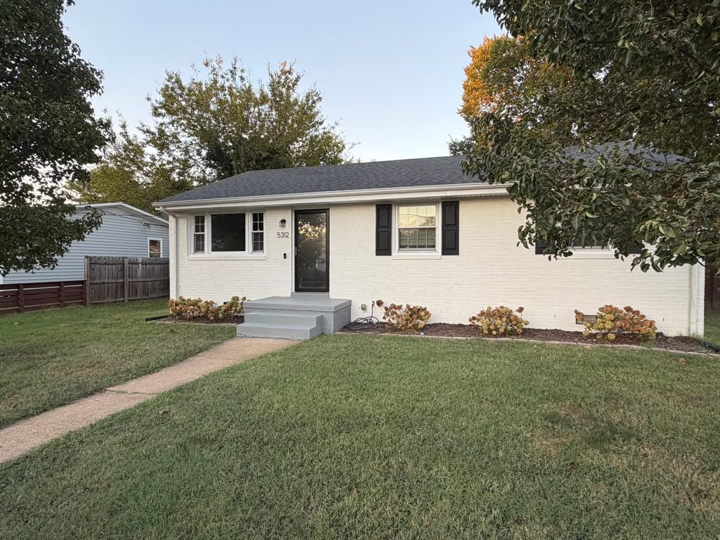 5312 Marian St &mdash; painted brick one-level ranch with black shutters, front walk and lawn