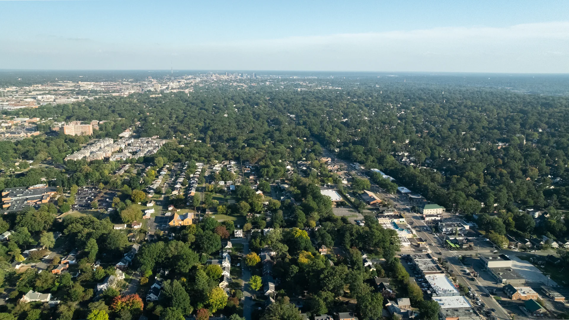 5312 Marian St &mdash; wide aerial over the tree-lined streets around the house