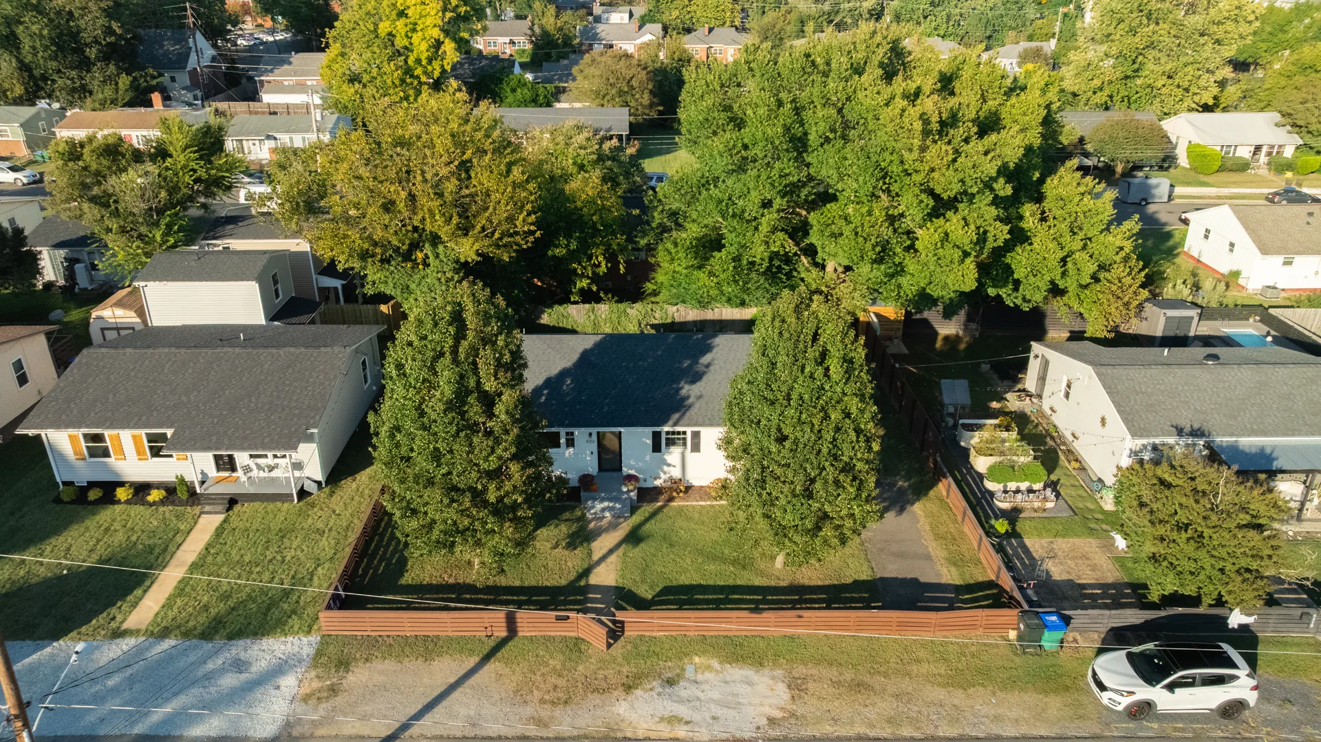 5312 Marian St &mdash; aerial view of the house and its fenced lot from above the street