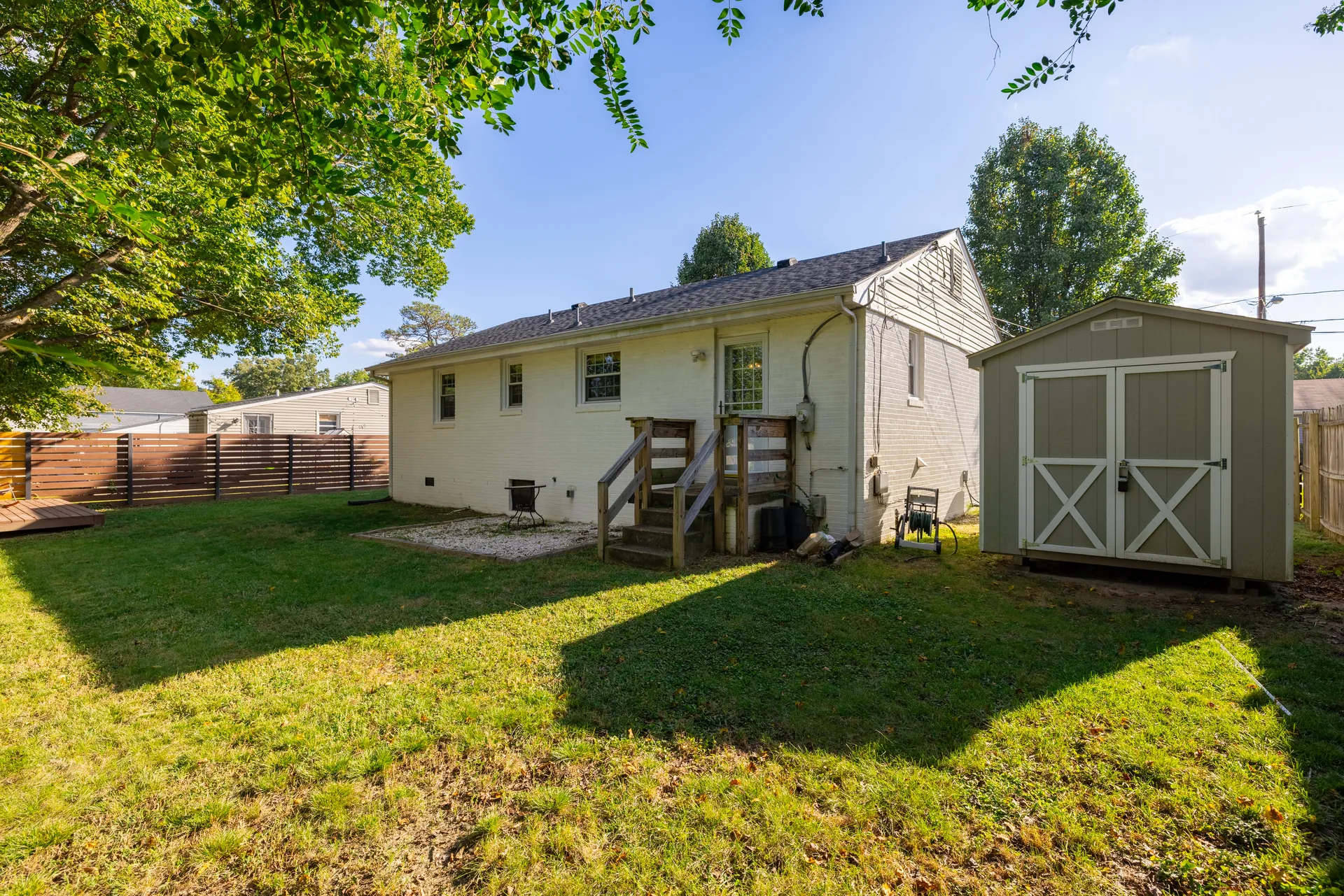 5312 Marian St &mdash; rear of the house with the storage shed and back steps
