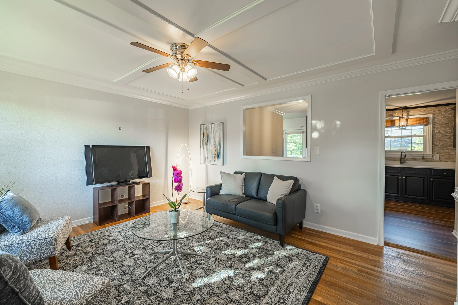 5312 Marian St &mdash; living room with a ceiling fan, looking toward the kitchen