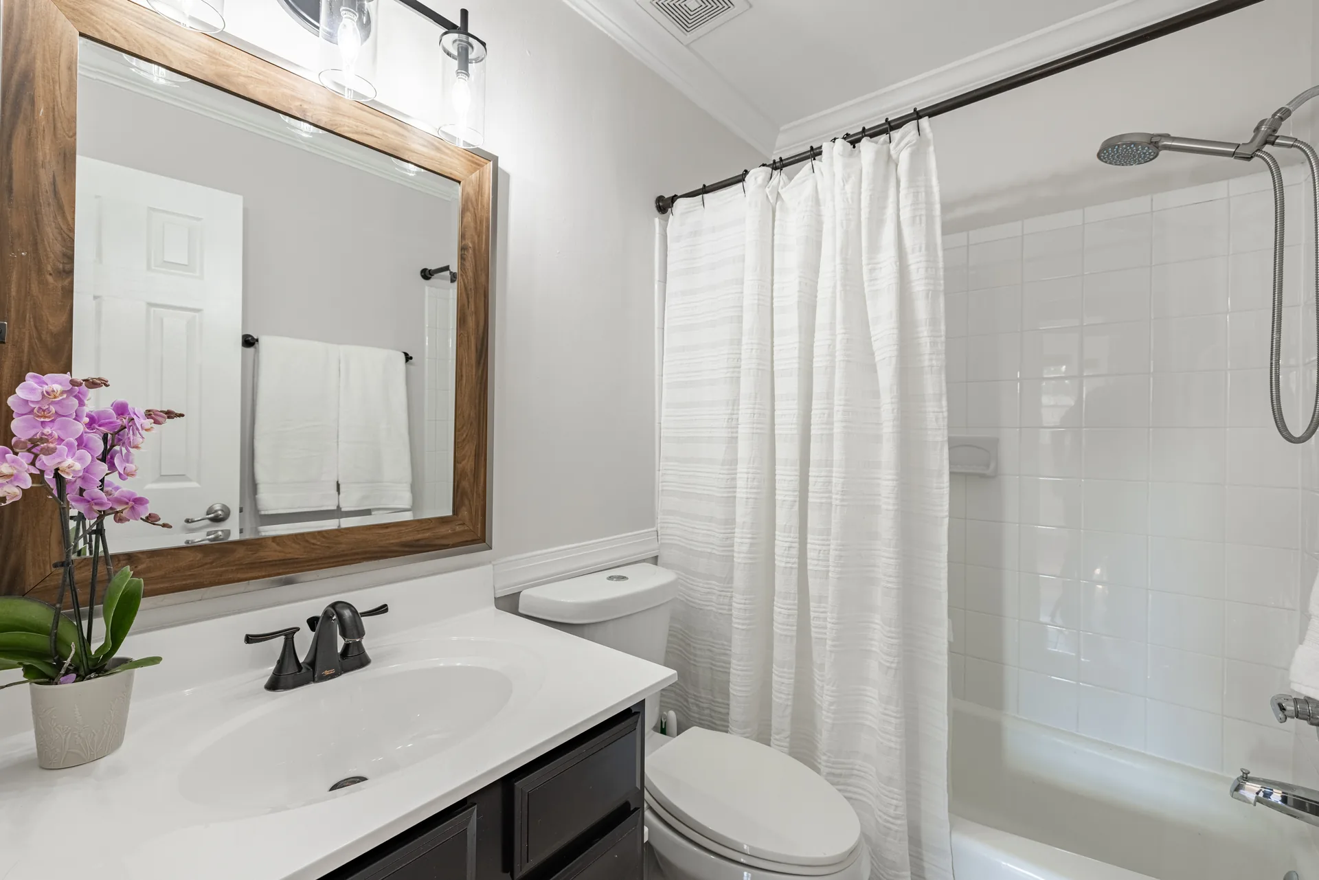 5312 Marian St &mdash; full hall bath with a framed mirror, vanity and tub-shower
