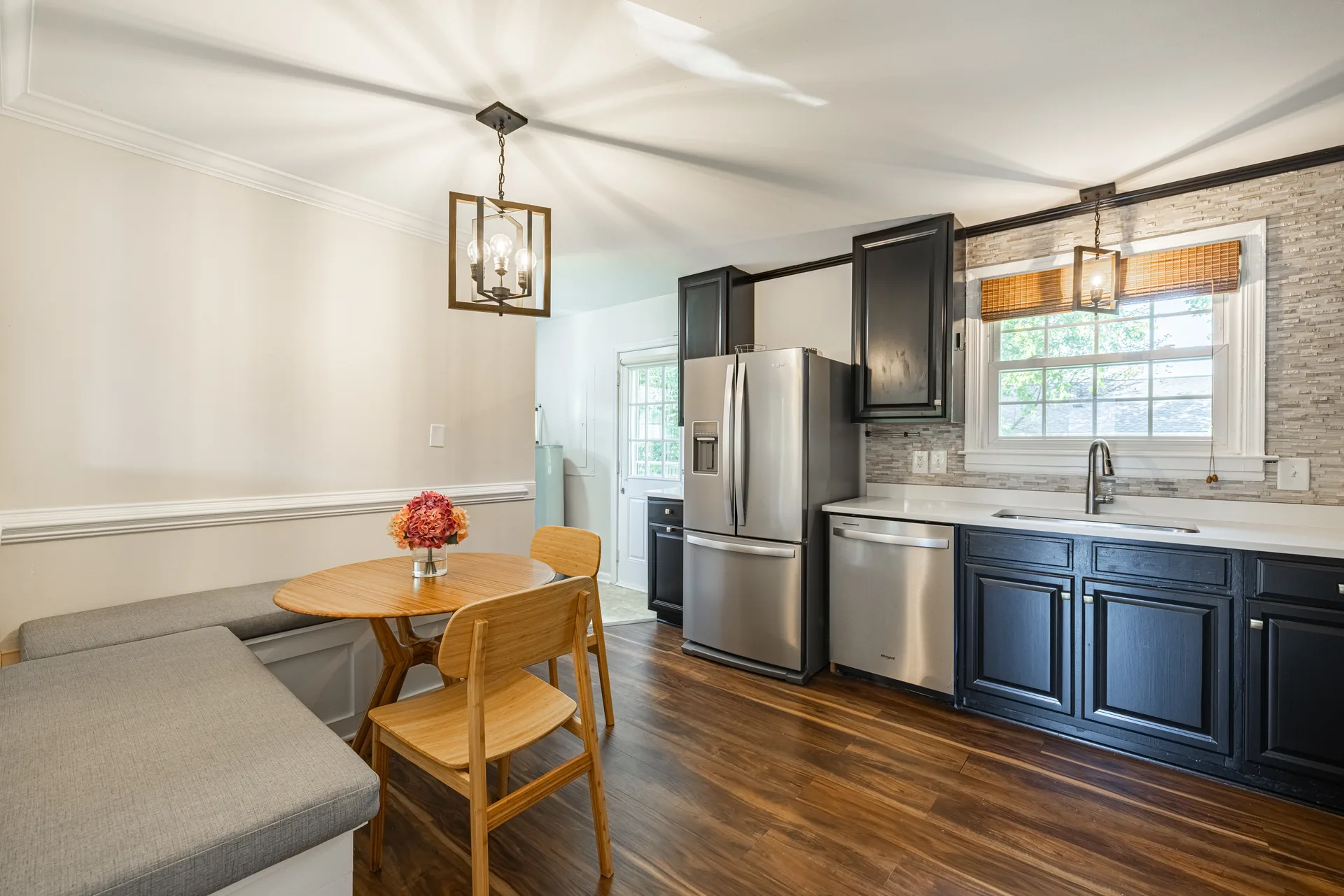 5312 Marian St &mdash; kitchen looking through to the dining nook, with a stainless refrigerator and dark cabinets