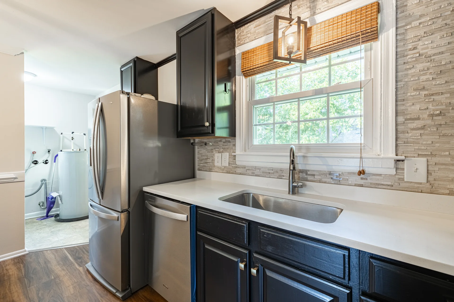 5312 Marian St &mdash; kitchen sink and dishwasher under the window, laundry room beyond