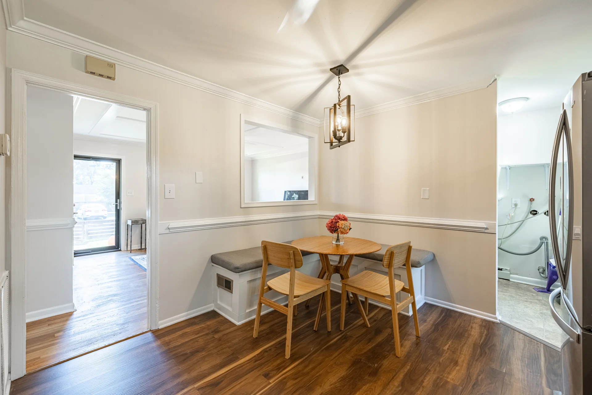 5312 Marian St &mdash; dining nook with a built-in banquette, open to the living room
