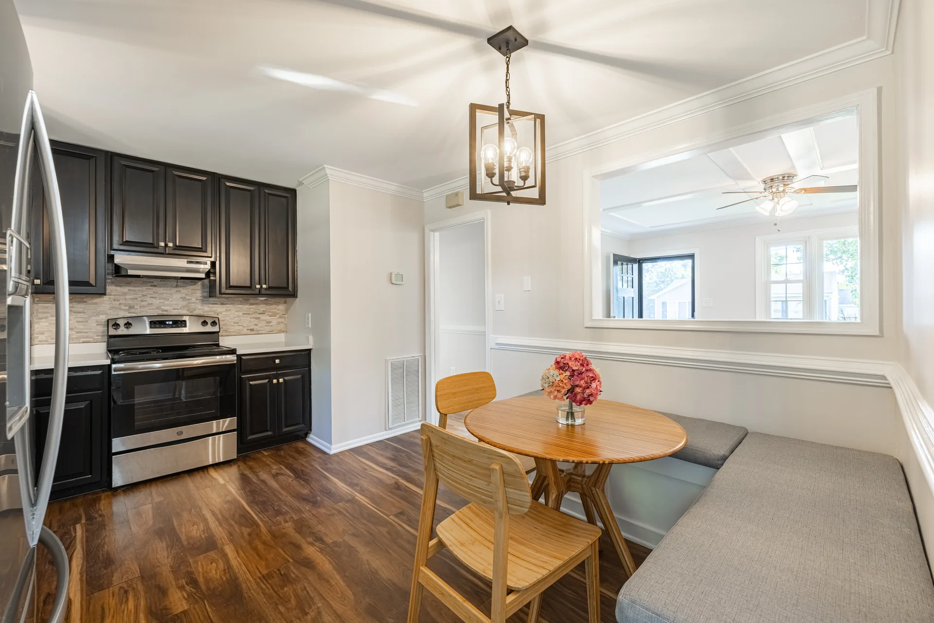 5312 Marian St &mdash; kitchen and dining nook together, with the range and pendant light