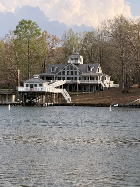 Waterfront home with a cupola and boathouse with stairs to the dock in Lake Anna, Virginia