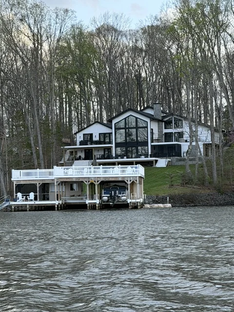 Contemporary white waterfront home with a two-story boathouse and covered slip in Lake Anna, Virginia