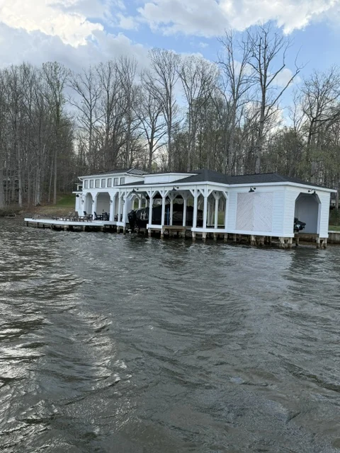 White covered boathouse with multiple slips and a lakeside dock in Lake Anna, Virginia