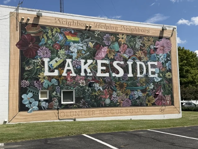 The Lakeside community mural, painted with flowers and the words Neighbors Helping Neighbors, in Lakeside, Henrico County