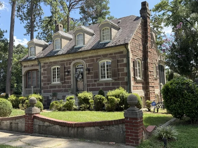 Stone and brick home behind a low garden wall in Lakeside, Henrico County
